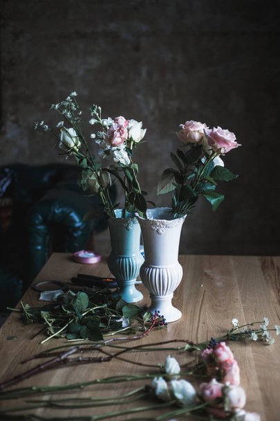 Florist workplace: flowers and accessories on a vintage wooden table. soft focus - Photo, image