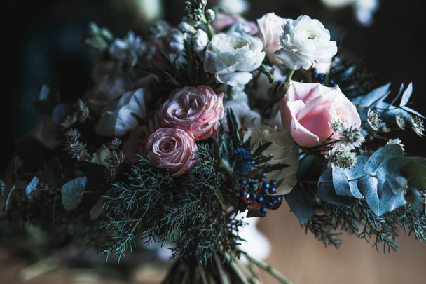 Florist workplace: flowers and accessories on a vintage wooden table. soft focus. Modern bouquet in a vase on a table, simple composition - Foto, Imagem