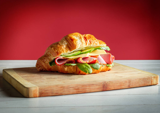 Croissants sandwiches on the wooden cutting board - 写真・画像