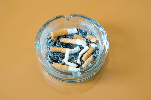 cigarettes in glass ashtray isolated - Photo, Image