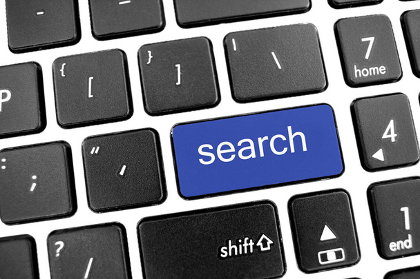 Teclado moderno negro plano de un portátil con botón azul: búsqueda
 - Foto, Imagen