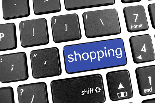 Teclado moderno negro plano de un ordenador portátil con botón azul: shoppin
 - Foto, Imagen