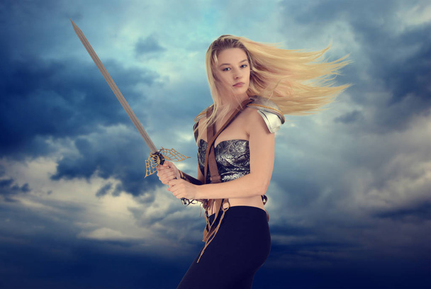 woman warrior with cloudy sky background - Zdjęcie, obraz