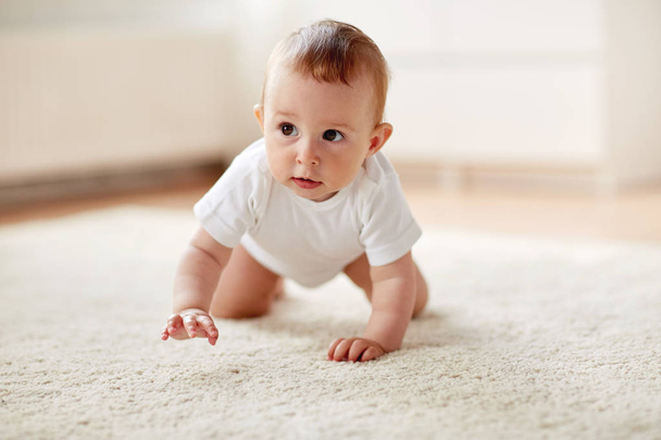 little baby in diaper crawling on floor at home - Photo, image