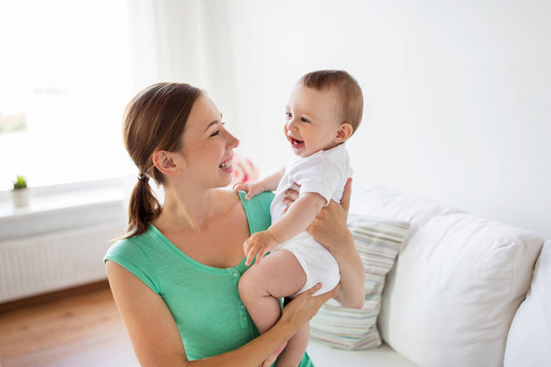 happy young mother with little baby at home - Fotoğraf, Görsel