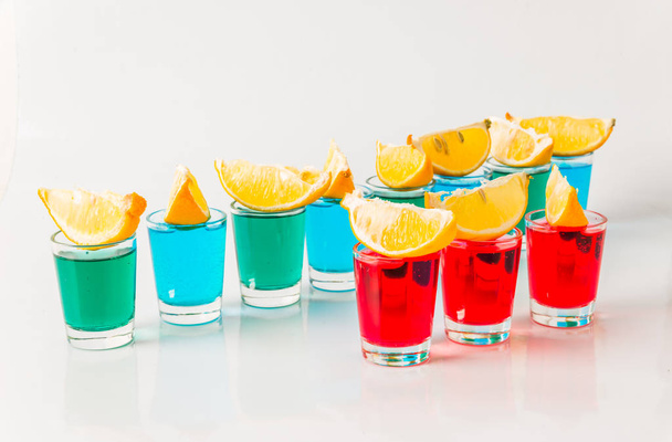 Glasses with blue, green and red kamikaze, glamorous drinks, mix - Photo, Image