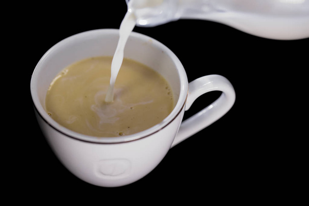 milk poured in a Cup of coffee - Φωτογραφία, εικόνα