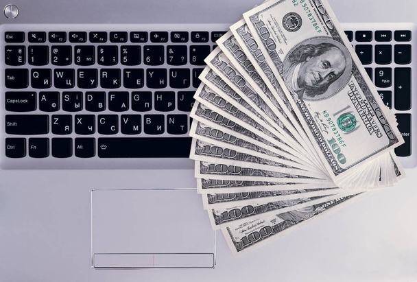 Banknotes over laptop keyboard - Foto, Imagem