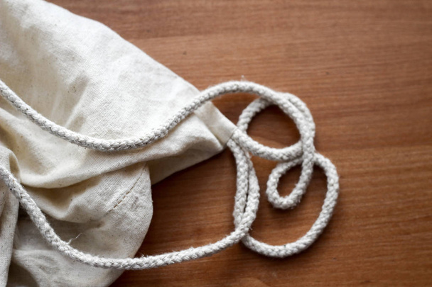 White cotton sack on wooden back ground close up - Valokuva, kuva
