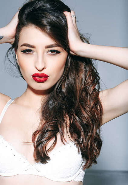 sexy woman with red lips, long hair in white bra - Fotó, kép