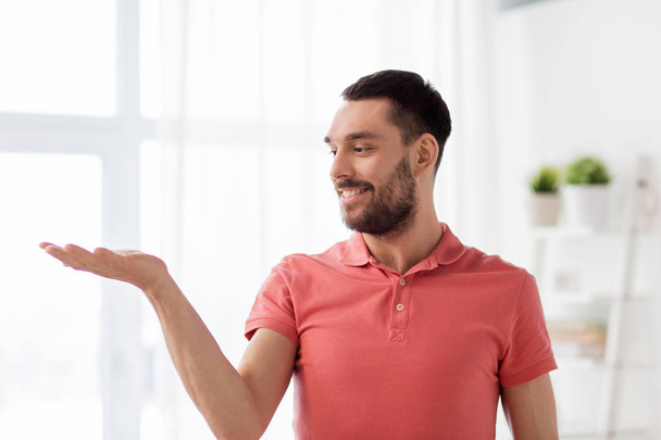 happy man holding something imaginary at home - Фото, зображення