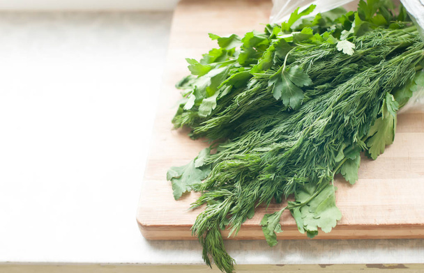 Dill and parsley on the cutting board - Φωτογραφία, εικόνα