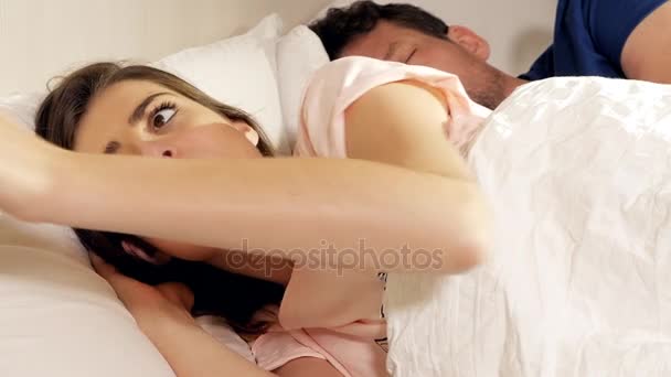 Woman cheating on sleeping husband chatting with lover on cell phone at night - Footage, Video