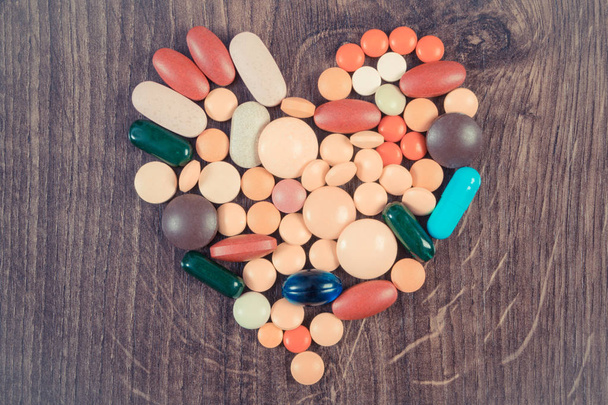 Vintage photo, Heart shaped colorful medical pills and capsules, health care concept - 写真・画像
