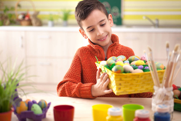  Happy boy holding colorfull Easter basket - Foto, afbeelding