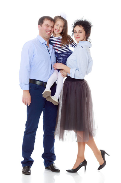 Happy parents with a small daughter. - Фото, зображення