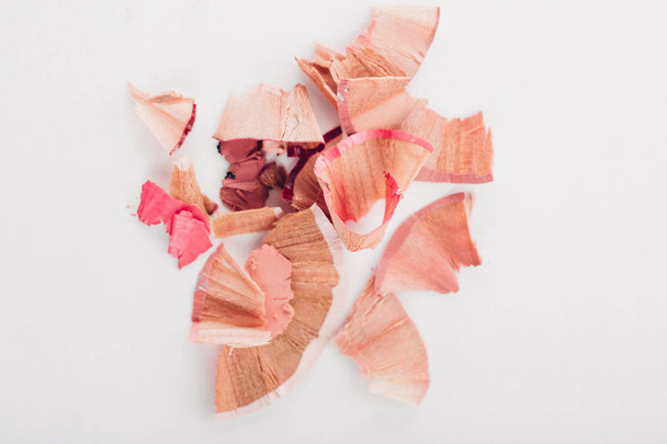 cosmetic pink pencil shavings on white background - Foto, afbeelding