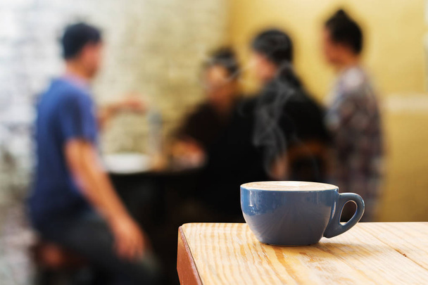 Coffee cup with stream of vapour against Adult meeting or discus - Photo, Image