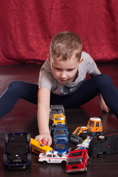 Many toy cars, little boy playing on the floor, - Photo, Image