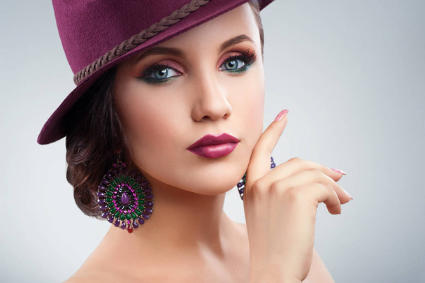 Gorgeous elegant woman in a hat posing in studio - Fotó, kép