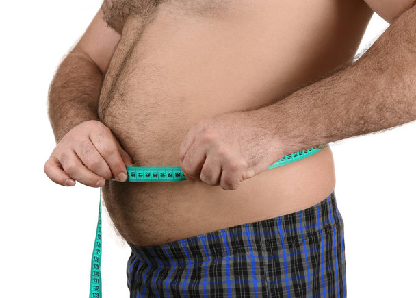 Man measuring beer belly  - Foto, afbeelding