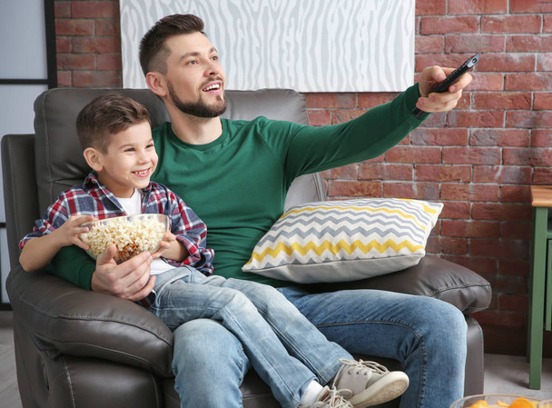 Father and son watching TV  - Фото, зображення