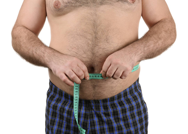 Man measuring beer belly  - 写真・画像