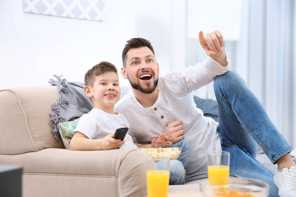 Father and son watching TV  - Foto, imagen