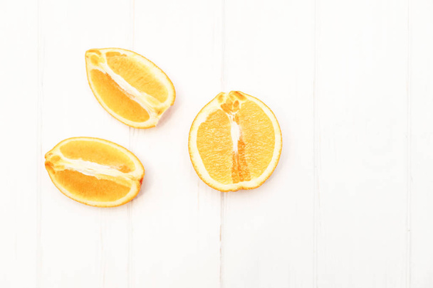 Slices of orange on a wooden white background - Foto, immagini