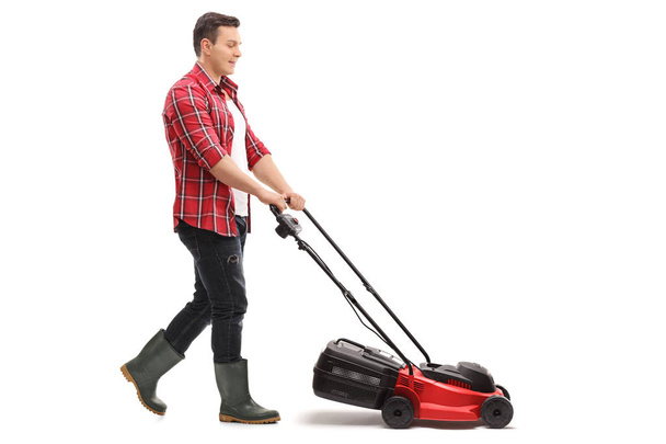 Gardener mowing with a lawnmower - Zdjęcie, obraz