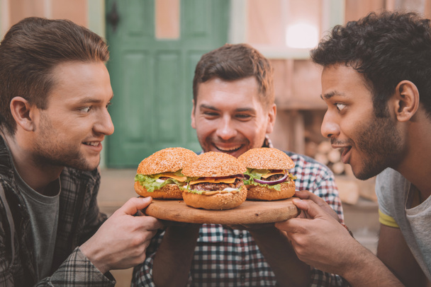 Men eating hamburgers  - Φωτογραφία, εικόνα