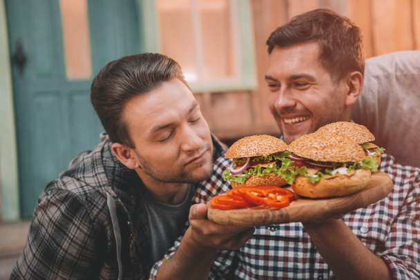 Men eating hamburgers  - Fotó, kép