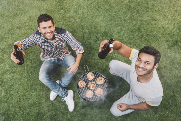 Friends drinking beer and making barbecue  - 写真・画像