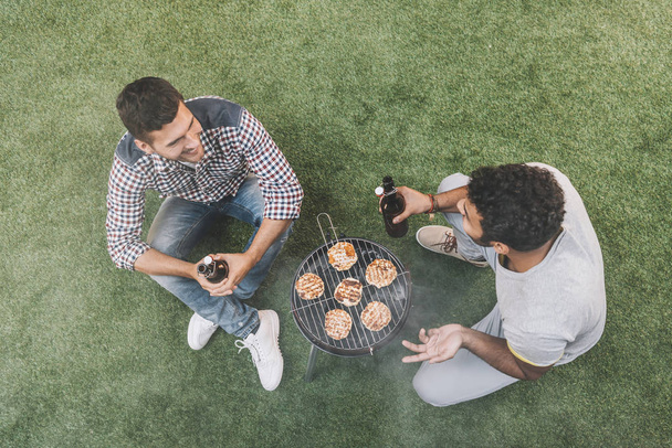 Friends drinking beer and making barbecue  - 写真・画像