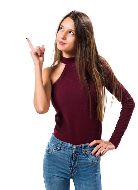 Young teenager girl pointing up - Foto, afbeelding