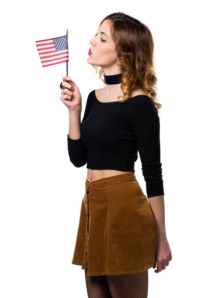 Beautiful young girl holding an american flag - 写真・画像