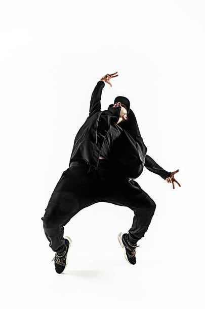 The silhouette of one hip hop male break dancer dancing on white background - Photo, image