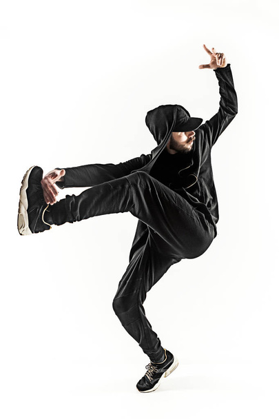 The silhouette of one hip hop male break dancer dancing on white background - Photo, Image