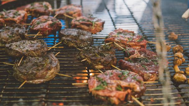 steak barbecue on the grill. Cooking steak outdoors. Shallow focus - 写真・画像