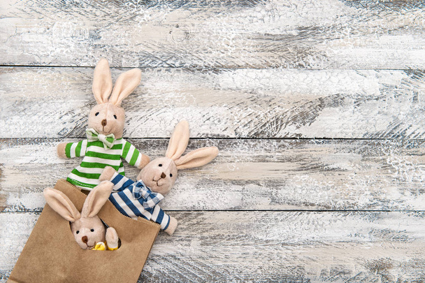Easter decoration bunnies gift bag wooden background - Foto, Imagem