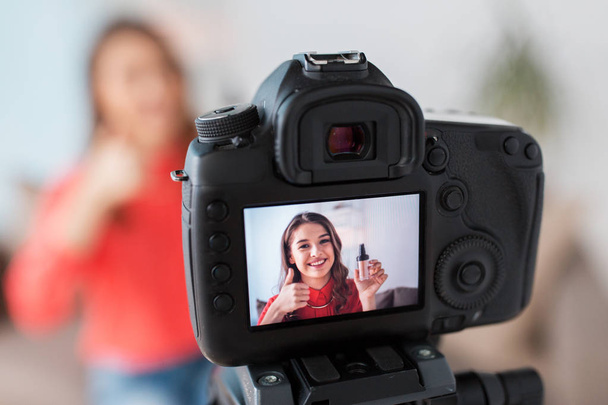 woman with foundation and camera recording video - Fotoğraf, Görsel