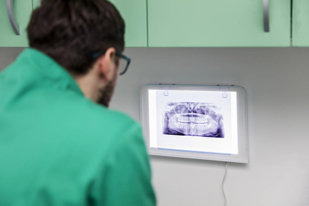 Dentista che analizza i raggi X
 - Foto, immagini