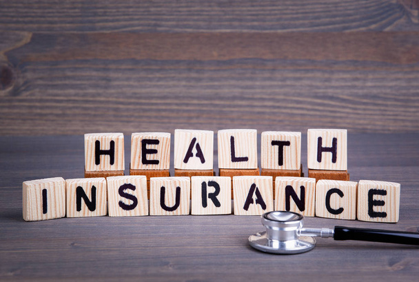 Health insurance from wooden letters. Abstract business and success background - Фото, зображення