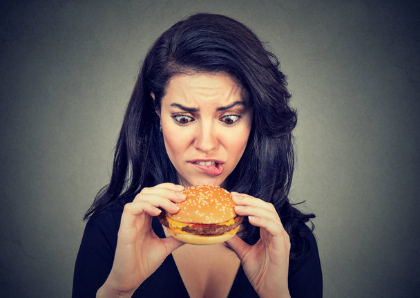 Young woman craving a tasty burger - Фото, изображение