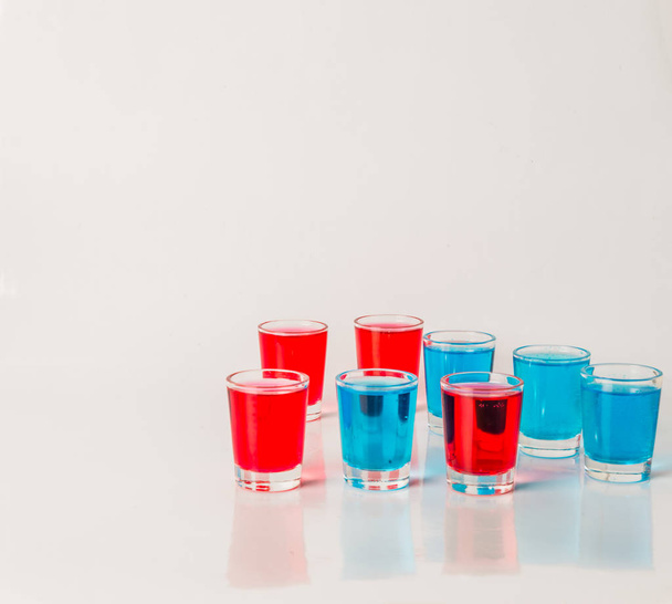Glasses with blue and red kamikaze, glamorous drinks, mixed drin - Photo, Image