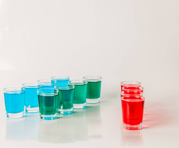 Glasses with blue, green and red kamikaze, glamorous drinks, mix - Photo, Image