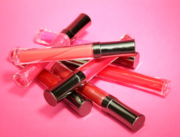 beautiful lip glosses, on pink background - Valokuva, kuva