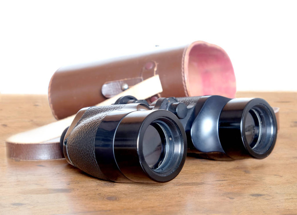 Vintage prism black color binoculars and brown leather case - Photo, image