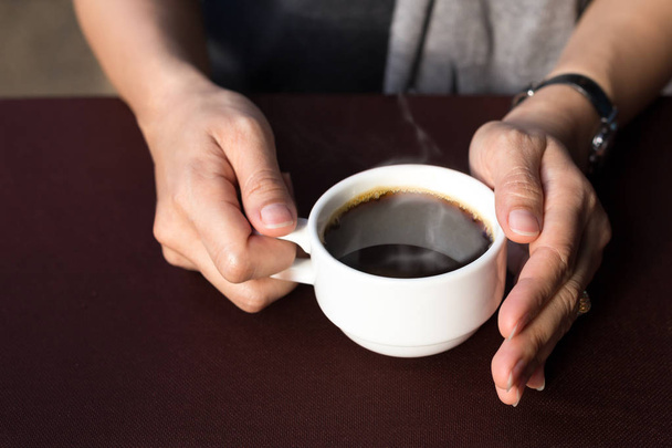 Woman hands holding hot coffee cup  - Фото, изображение