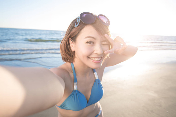 woman in bikini taking  selfie  - 写真・画像